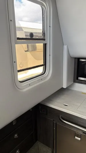  Yacht Photos Pics Interior view of 2022 Formula 350 CBR boat cabin with window and cabinetry.