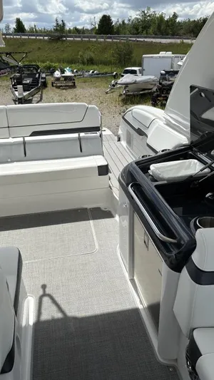  Yacht Photos Pics 2022 Formula 350 CBR boat interior with seating and kitchenette, parked outdoors.