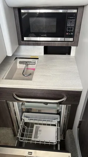  Yacht Photos Pics 2022 Formula 350 CBR boat kitchenette with microwave, sink, and storage drawers.