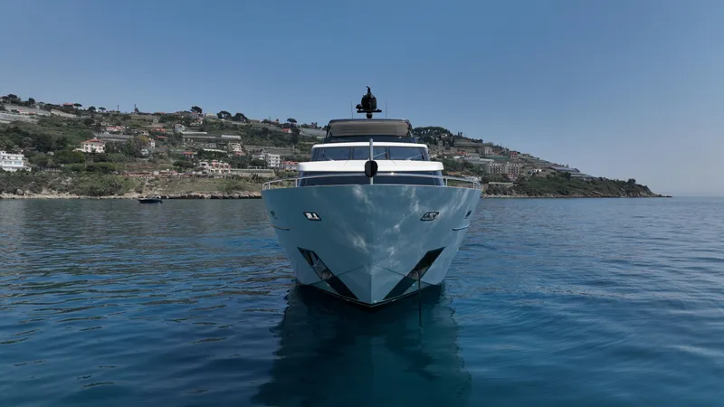 Aman - Sanlorenzo Sl96 Yacht Photos Pics Sanlorenzo SL96 yacht, 2016 model, cruising on serene waters with coastal backdrop.