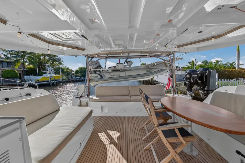 White Heron Yacht Photos Pics Spacious deck of 2021 Lagoon 46 Owner's Version catamaran with seating and dining area.
