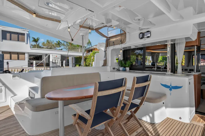 White Heron Yacht Photos Pics Spacious deck of 2021 Lagoon 46 Owner's Version catamaran with seating and dining area.