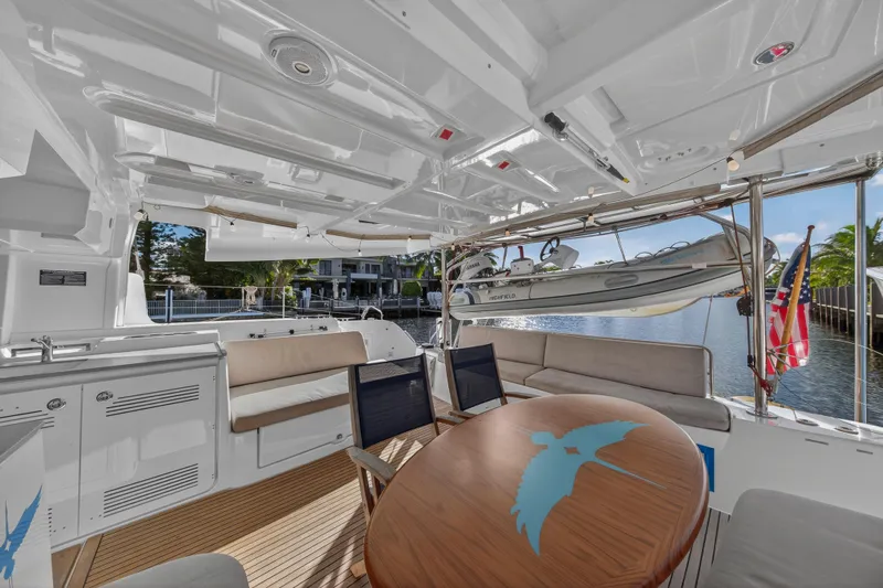 White Heron Yacht Photos Pics Luxurious 2021 Lagoon 46 Owner's Version yacht interior with elegant seating and scenic waterfront view.