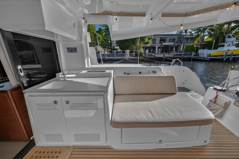White Heron Yacht Photos Pics Luxurious Lagoon 46 Owner's Version yacht interior with seating and kitchenette, 2021 model.