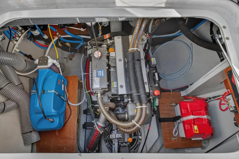 White Heron Yacht Photos Pics Engine compartment of 2021 Lagoon 46 Owner's Version catamaran, showcasing mechanical components and wiring.