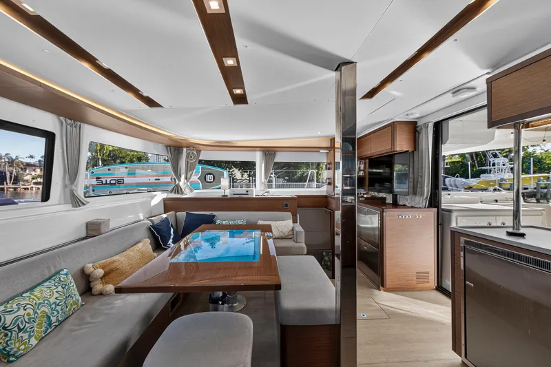 White Heron Yacht Photos Pics Luxurious interior of 2021 Lagoon 46 Owner's Version catamaran with modern furnishings and ample natural light.