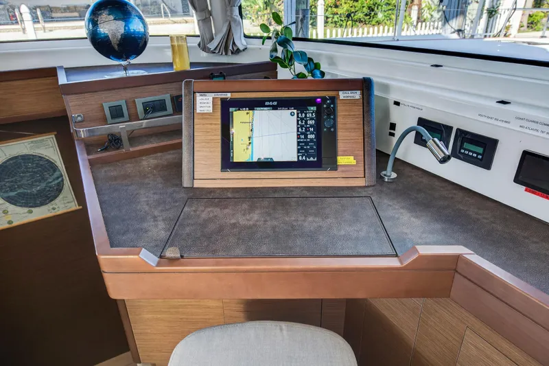 White Heron Yacht Photos Pics Navigation station of 2021 Lagoon 46 Owner's Version catamaran with chart plotter and globe.