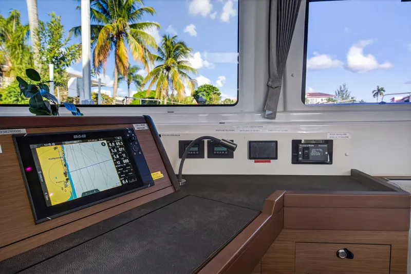 White Heron Yacht Photos Pics Navigation station inside 2021 Lagoon 46 Owner's Version catamaran with tropical view.