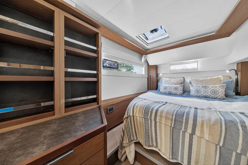 White Heron Yacht Photos Pics Luxurious bedroom interior of 2021 Lagoon 46 Owner's Version yacht with skylight and cozy bedding.
