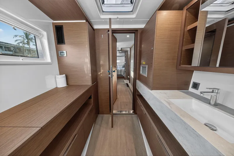 White Heron Yacht Photos Pics Luxurious interior of 2021 Lagoon 46 Owner's Version yacht, featuring modern wood finishes.