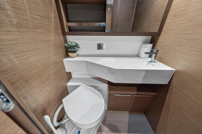 White Heron Yacht Photos Pics Modern bathroom in 2021 Lagoon 46 Owner's Version yacht with sleek design and compact fixtures.