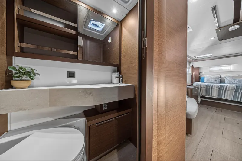 White Heron Yacht Photos Pics Luxurious interior of 2021 Lagoon 46 Owner's Version yacht, featuring modern bathroom and cozy bedroom.