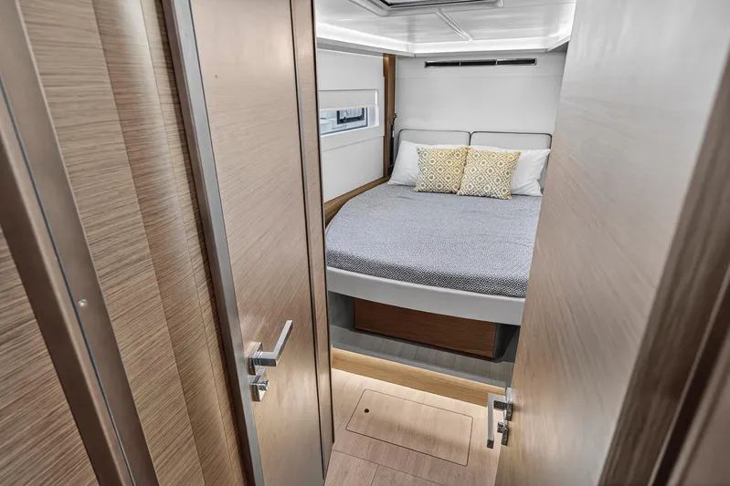 White Heron Yacht Photos Pics Luxurious bedroom in 2021 Lagoon 46 Owner's Version catamaran, featuring modern design and cozy bedding.