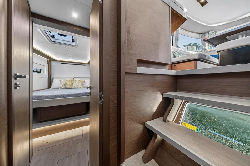 White Heron Yacht Photos Pics Luxurious interior of 2021 Lagoon 46 Owner's Version yacht, featuring a cozy bedroom and modern design.