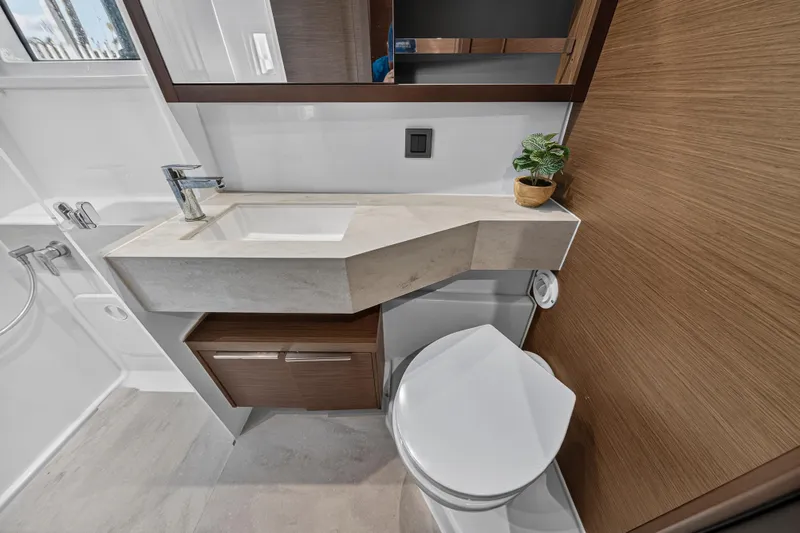 White Heron Yacht Photos Pics Modern bathroom in 2021 Lagoon 46 Owner's Version yacht, featuring sleek sink and toilet.