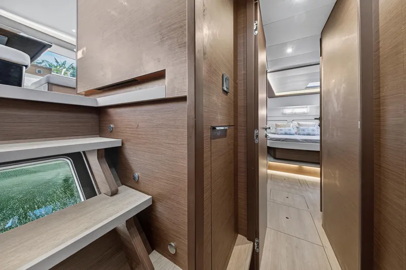 White Heron Yacht Photos Pics Interior of 2021 Lagoon 46 Owner's Version yacht, featuring modern wood finishes and cozy bedroom.