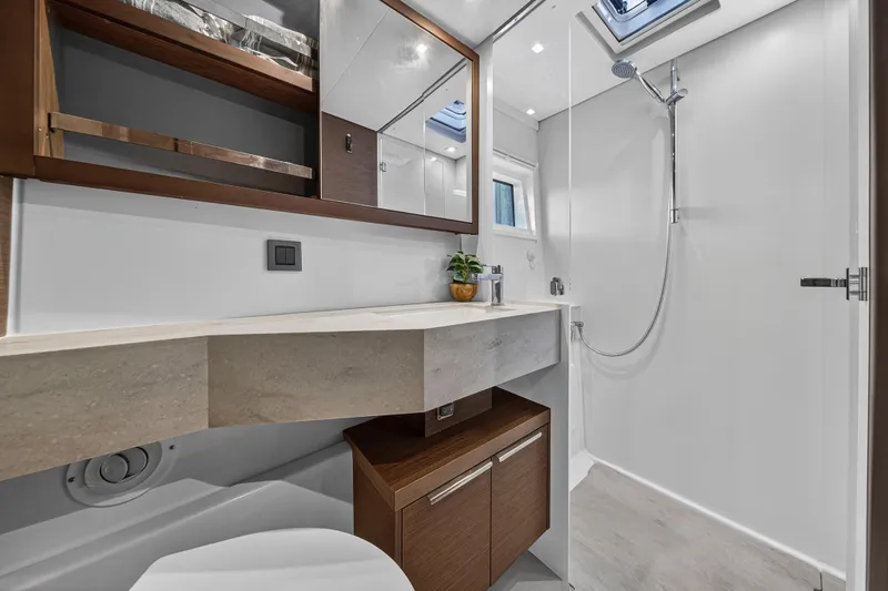 White Heron Yacht Photos Pics Luxurious bathroom in 2021 Lagoon 46 Owner's Version yacht, featuring modern fixtures and elegant design.