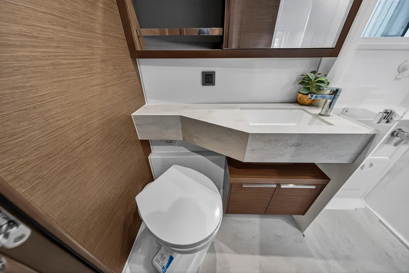 White Heron Yacht Photos Pics Modern bathroom in 2021 Lagoon 46 Owner's Version yacht, featuring sleek design and compact fixtures.