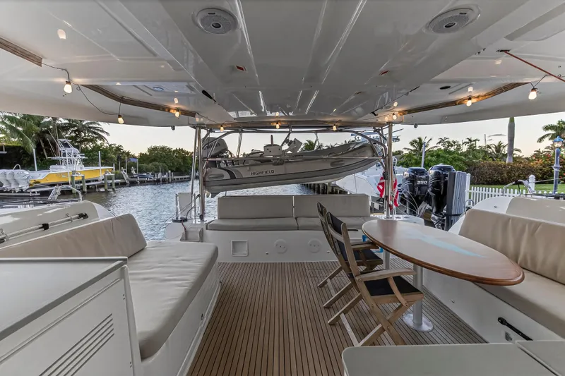 White Heron Yacht Photos Pics Spacious deck of 2021 Lagoon 46 Owner's Version yacht with seating and table.