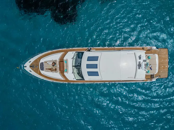 Yacht Photos Pics Aerial view of 2016 Princess V72 yacht on clear blue water.