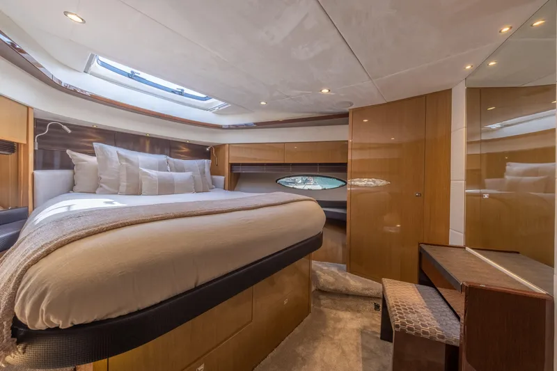  Yacht Photos Pics Luxurious interior of 2016 Princess V72 yacht bedroom with elegant wood finishes.