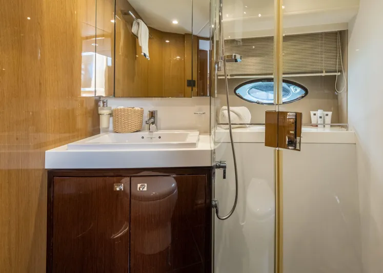  Yacht Photos Pics Luxurious bathroom in 2016 Princess V72 yacht with modern fixtures and elegant wood finishes.