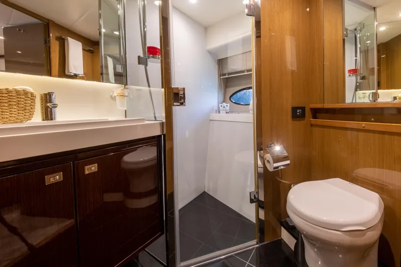  Yacht Photos Pics Luxurious bathroom in 2016 Princess V72 yacht with modern fixtures and wood accents.