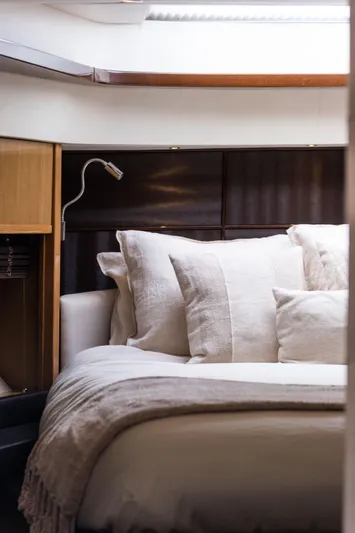  Yacht Photos Pics Luxurious interior of 2016 Princess V72 yacht with elegant bedding and modern lighting.