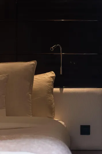  Yacht Photos Pics Luxurious bedroom interior on 2016 Princess V72 yacht, featuring elegant bedding and modern lighting.