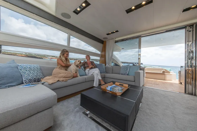  Yacht Photos Pics Luxurious 2016 Princess V72 yacht interior with people relaxing on a spacious sofa.