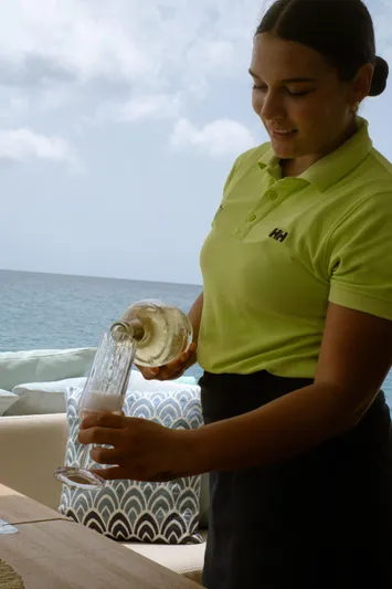  Yacht Photos Pics Person pouring drink on a yacht with ocean view, Princess V72, 2016.