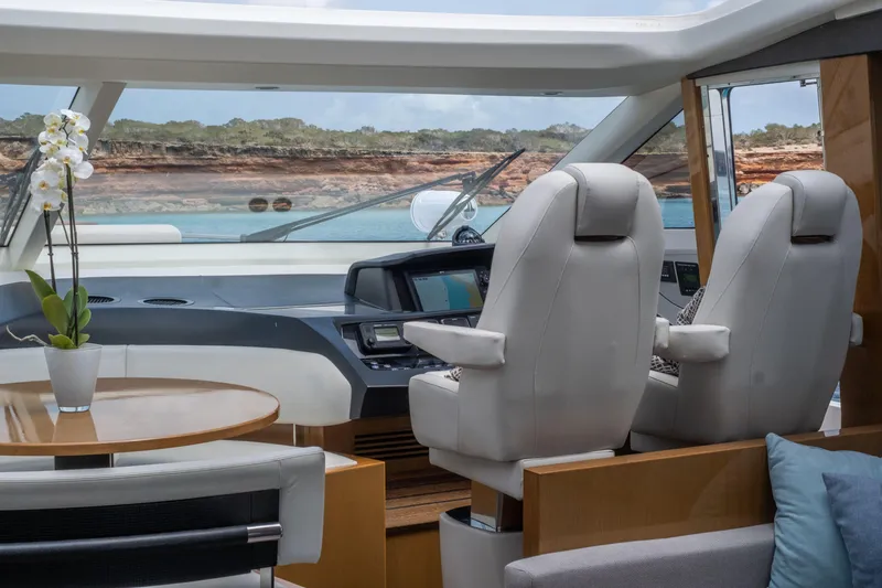  Yacht Photos Pics Luxurious interior of 2016 Princess V72 yacht with modern helm and seating.