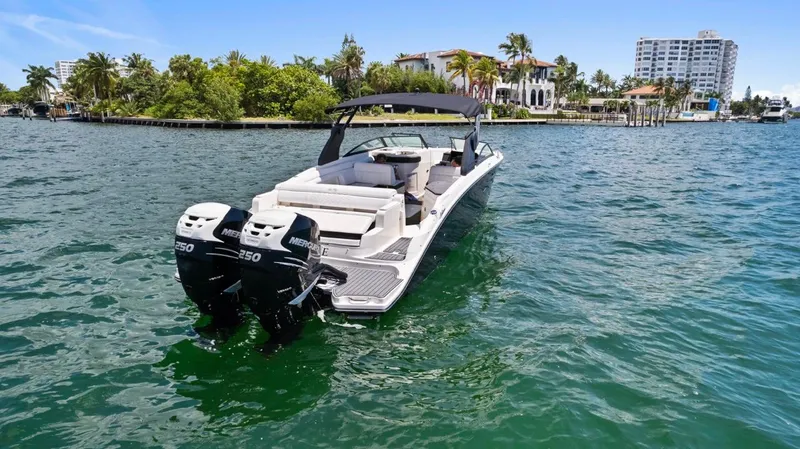  Yacht Photos Pics 2018 Sea Ray SDX 290 boat with dual Mercury engines on a sunny waterway.