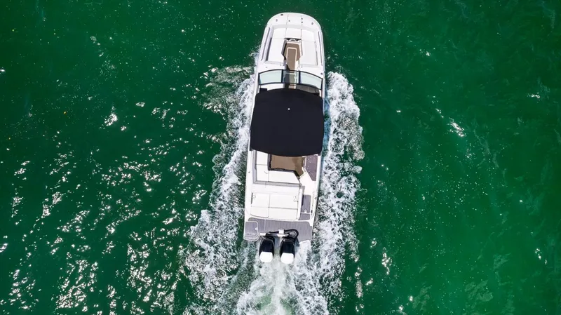  Yacht Photos Pics Aerial view of 2018 Sea Ray SDX 290 boat cruising on green water.