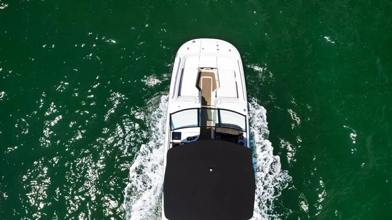  Yacht Photos Pics 2018 Sea Ray SDX 290 boat cruising on vibrant green water, aerial view.