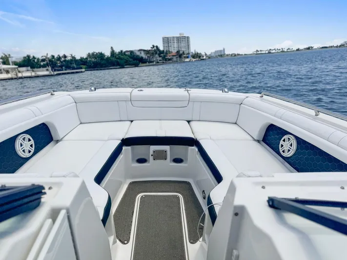  Yacht Photos Pics 2018 Sea Ray SDX 290 boat interior with white seating, on a calm waterway.