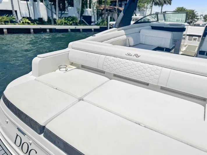  Yacht Photos Pics 2018 Sea Ray SDX 290 boat with white seating, docked by the water.