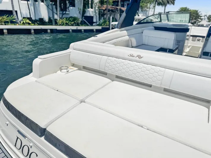  Yacht Photos Pics 2018 Sea Ray SDX 290 boat with white seating, docked by the water.