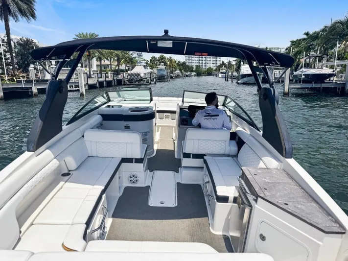  Yacht Photos Pics 2018 Sea Ray SDX 290 boat with spacious seating, cruising in a marina.