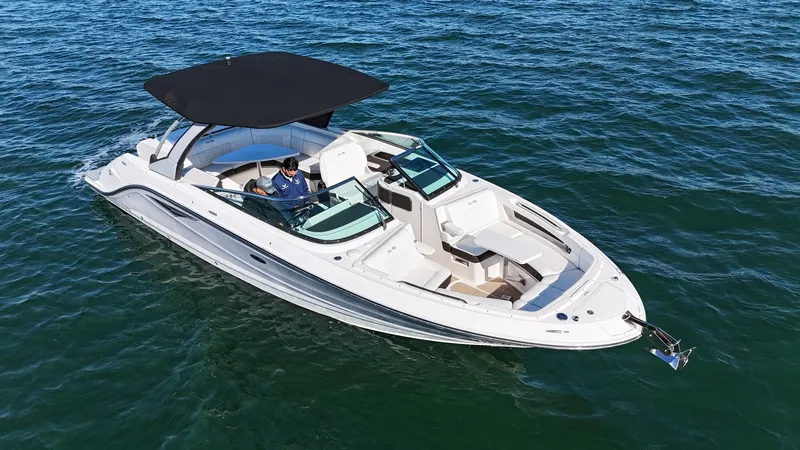  Yacht Photos Pics 2019 Sea Ray SLX 310 boat cruising on open water with black canopy.