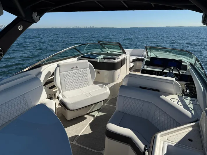  Yacht Photos Pics 2019 Sea Ray SLX 310 boat interior on open water, featuring luxurious seating and dashboard.