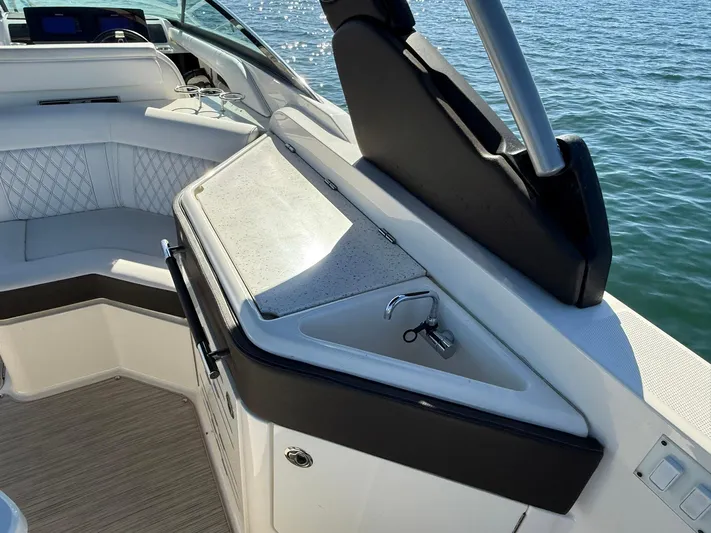  Yacht Photos Pics 2019 Sea Ray SLX 310 boat interior with seating and sink, on calm water.