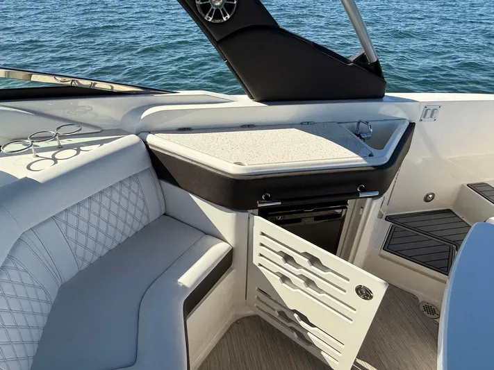  Yacht Photos Pics 2019 Sea Ray SLX 310 boat interior with seating and open storage compartment.