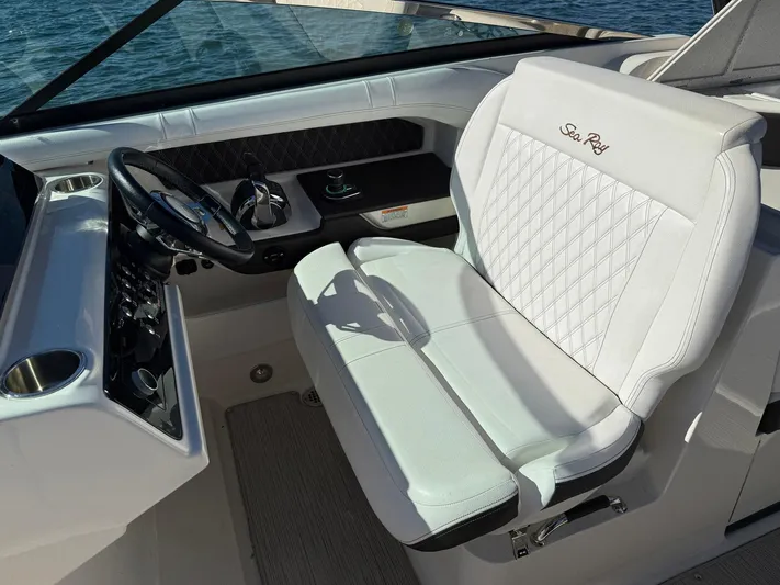  Yacht Photos Pics 2019 Sea Ray SLX 310 helm seat with luxurious white upholstery and steering wheel.
