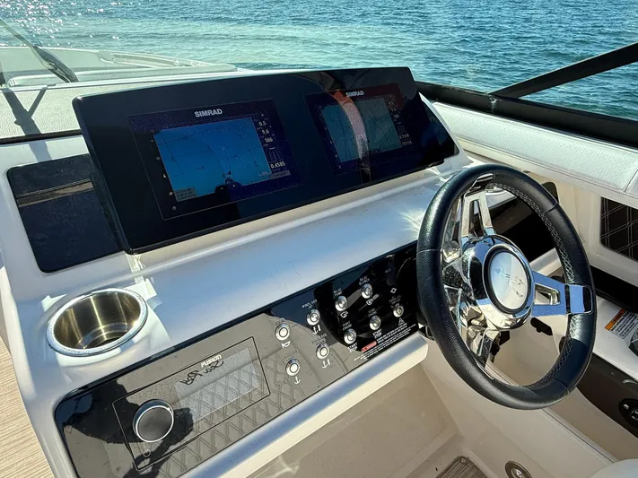  Yacht Photos Pics 2019 Sea Ray SLX 310 helm with dual Simrad displays and sleek steering wheel.