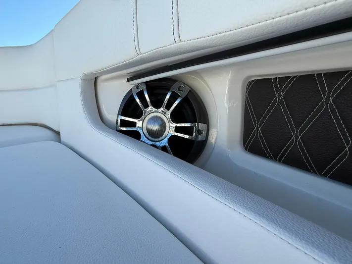  Yacht Photos Pics Speaker detail on 2019 Sea Ray SLX 310 boat with white upholstery and diamond-patterned trim.