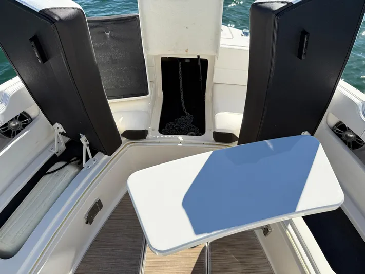  Yacht Photos Pics 2019 Sea Ray SLX 310 boat interior with seating and table, on calm water.