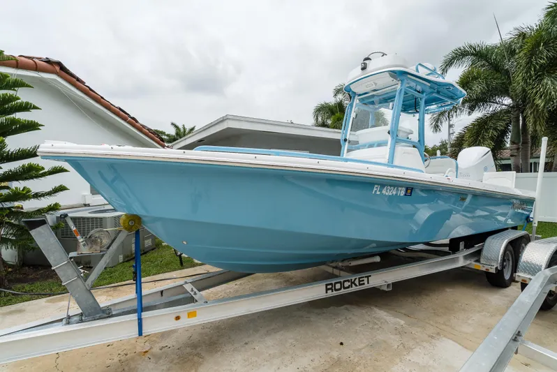  Yacht Photos Pics 2021 Everglades 243 Center Console boat on trailer, light blue, parked outdoors.