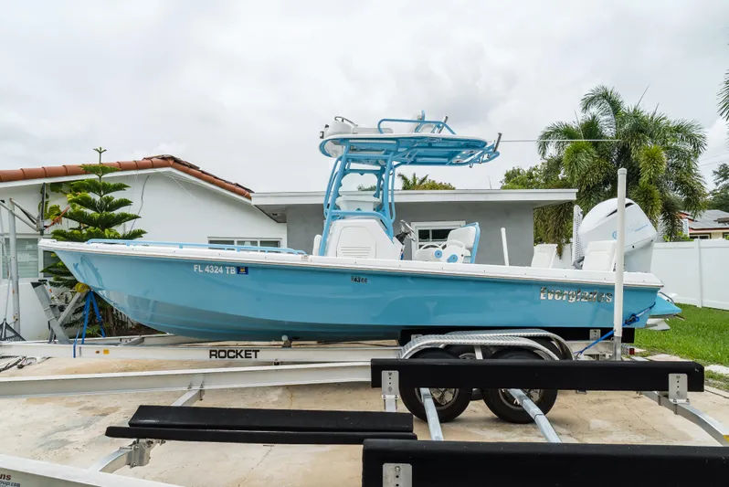  Yacht Photos Pics 2021 Everglades 243 Center Console boat on trailer, parked in residential driveway.