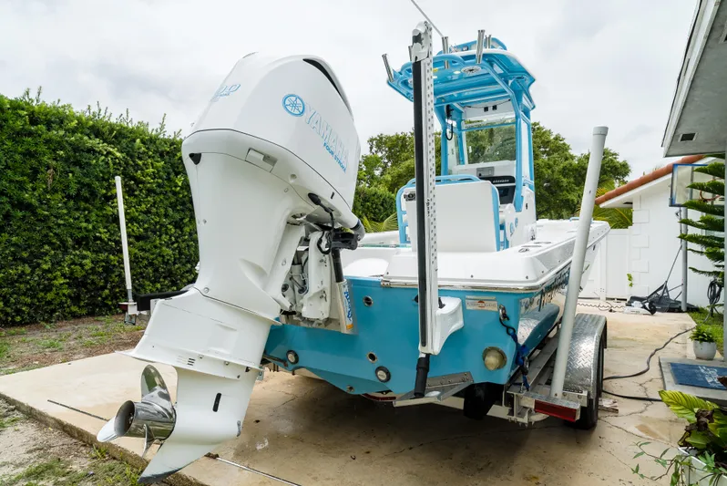  Yacht Photos Pics 2021 Everglades 243 Center Console boat on trailer, featuring powerful outboard motor.